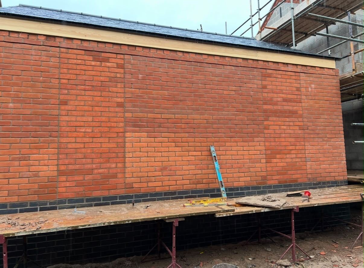 Large red-brick wall completed with consistent courses